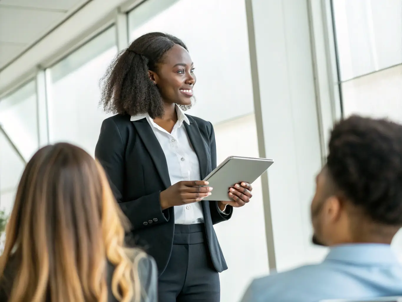 A South African woman entrepreneur confidently presenting a business plan to investors, highlighting her strategic vision and financial acumen.